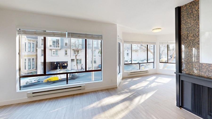 A large empty room with a view of the street outside.